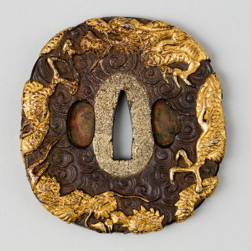 Anonymous artist - Tsuba (sword guard) decorated with a three-clawed dragon in clouds